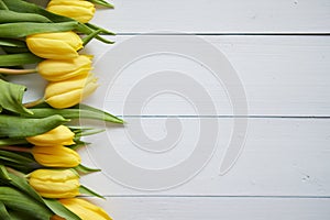 Row of fresh Yellow tulips on white wooden table