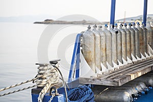 Row of full oxygen tanks for scuba diving