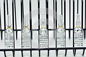 Row of glass ampoules photo