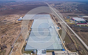 Row of glass greenhouses for vegetable production. aerial photo