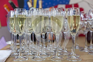 Row of glasses with champagne on the festive table. Celebrations and holidays. Front view
