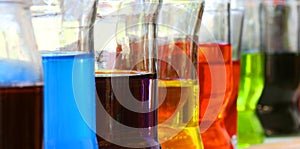 Row of glasses with colorful liquids