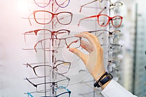 Row of glasses at an opticians. Eyeglasses shop. Stand with glasses in the store of optics