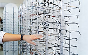 Row of glasses at an opticians. Eyeglasses shop. Stand with spectacles.