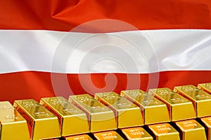 Row of gold bars on the Austria flag background. Concept of gold reserve and gold fund of Austria