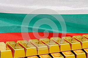 Row of gold bars on the Bulgaria flag background. Concept of gold reserve and gold fund of Bulgaria