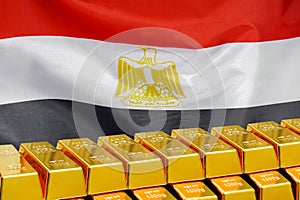 Row of gold bars on the Egypt flag background. Concept of gold reserve and gold fund of Egypt