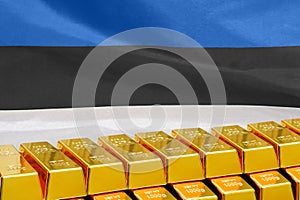 Row of gold bars on the Estonia flag background. Concept of gold reserve and gold fund of Estonia