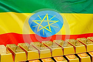 Row of gold bars on the Ethiopia flag background. Concept of gold reserve and gold fund of Ethiopia