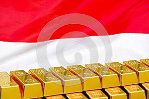 Row of gold bars on the Indonesia flag background. Concept of gold reserve and gold fund of Indonesia