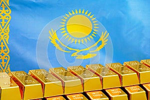 Row of gold bars on the Kazakhstan flag background. Concept of gold reserve and gold fund of Kazakhstan