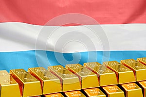 Row of gold bars on the Luxembourg flag background. Concept of gold reserve and gold fund of Luxembourg