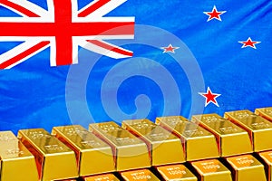 Row of gold bars on the New Zealand flag background. Concept of gold reserve and gold fund of New Zealand