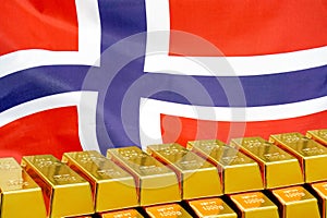 Row of gold bars on the Norway flag background. Concept of gold reserve and gold fund of Norway