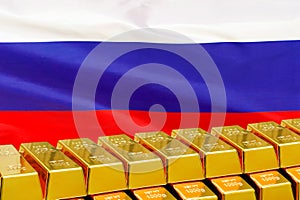 Row of gold bars on the Russia flag background. Concept of gold reserve and gold fund of Russia