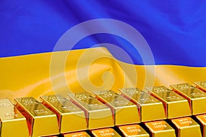 Row of gold bars on the Ukraine flag background. Concept of gold reserve and gold fund of Ukraine