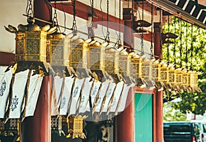 Row of gold plated japanese lanterns at Shitenno-ji buddhist temple. photo