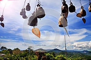 Row of golden bells in buddhist temple. Background of mountains in asia, tailandia photo