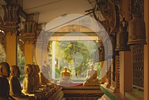 A row of golden buddha statue at Wat Intharam Kanchanaburi, Thai