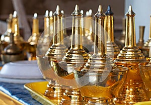 Row of golden flagons on tray