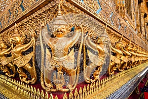 Row of golden garuda scuplture Wat Phra Kaew or the Temple of the Emerald Buddha