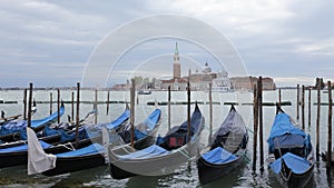 A row of gondolas and Church of San Giorgio Maggiore in the background