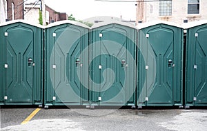 Row of Green Portable Toilets