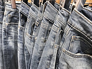 Row of hanged blue jeans pants