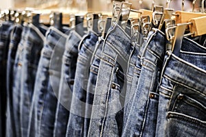 Row of hanged blue jeans pants in shop