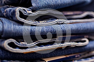 Row of hanged blue jeans in a shop