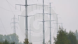 Row of high voltage towers holding electric wires