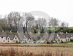 Row of historic quintessential Cotswold cottages in Bibury, England