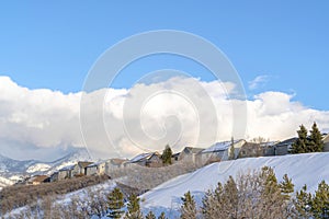 Row of homes on pristine snowy slope with unobstructed view of Wasatch Mountains