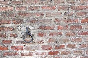 Row of hooks for clothes on the brick wall