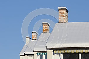 Row of house chimneys and rooftops wintertime