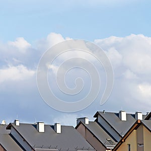 Row house roofs, large detailed panoramic roofscape, condo rowhouse rooftop detail panorama, multiple condos, bright blue summer