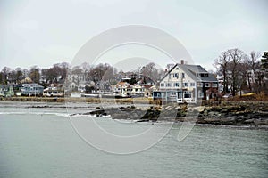 Row of houses on a quaint moody New England seascape coastline