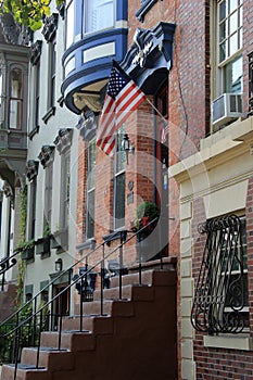 Row houses with welcoming potted plants at the front door