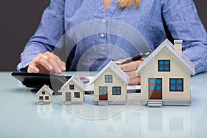 Row Of Increasing House Models On Desk