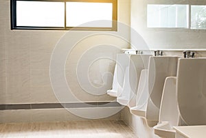 Row of indoor white urinals for man in toilet,Modern luxury design lavatory