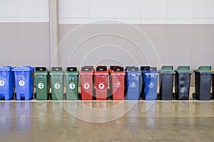 A row of industrial plastic garbage containers