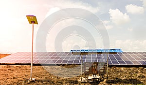 Row of installed Photovoltaic solar panels or modules, solar street light and string combiner box, string monitoring box with photo