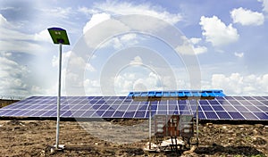 Row of installed Photovoltaic solar panels or modules, solar street light and string combiner box, string monitoring box with photo