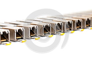 Row of Internet SFP Small Form-factor Pluggable network modules for network switch. Close up. Isolated