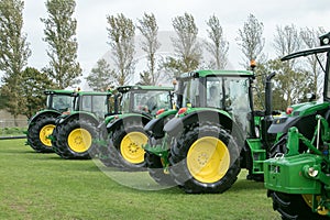 A row of John Deere Tractors at show