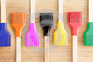 Row of kitchen brushes with colorful bristles