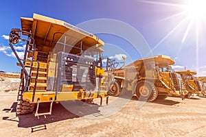 Row of large dumper trucks on construction site.