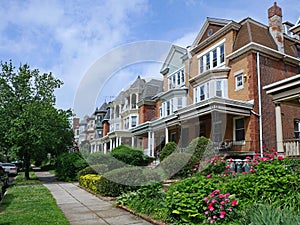 Row of large old brick houses with front porches