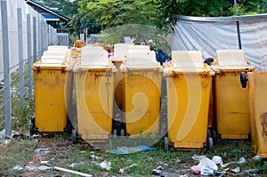 Row of large yellow wheelie bin