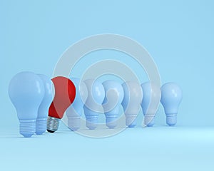 Row of light bulbs red one different idea from the others on light blue background